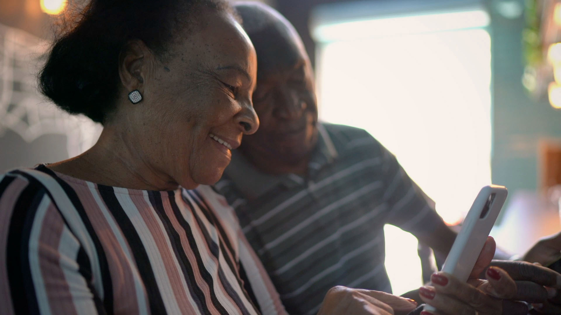 A couple uses a mobile device together.