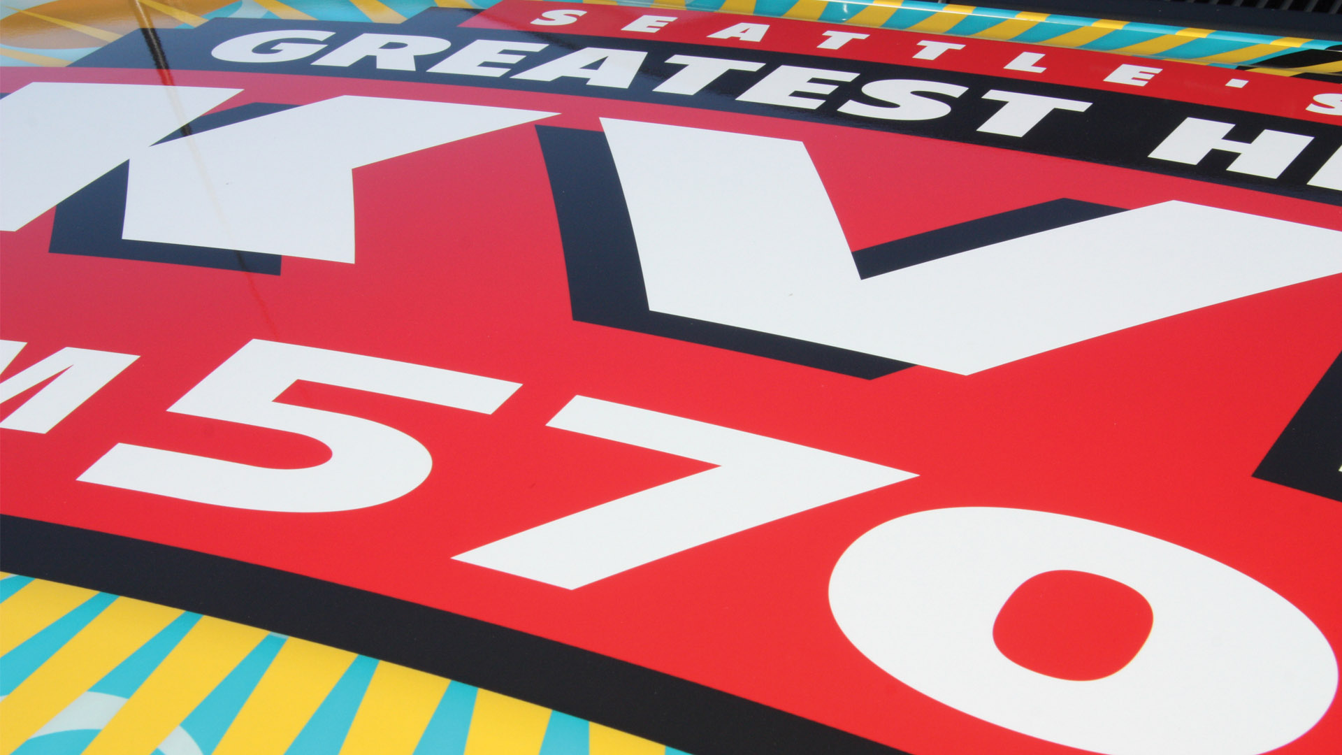 The hood of a vehicle wrapped for Seattle’s Greatest Hits.